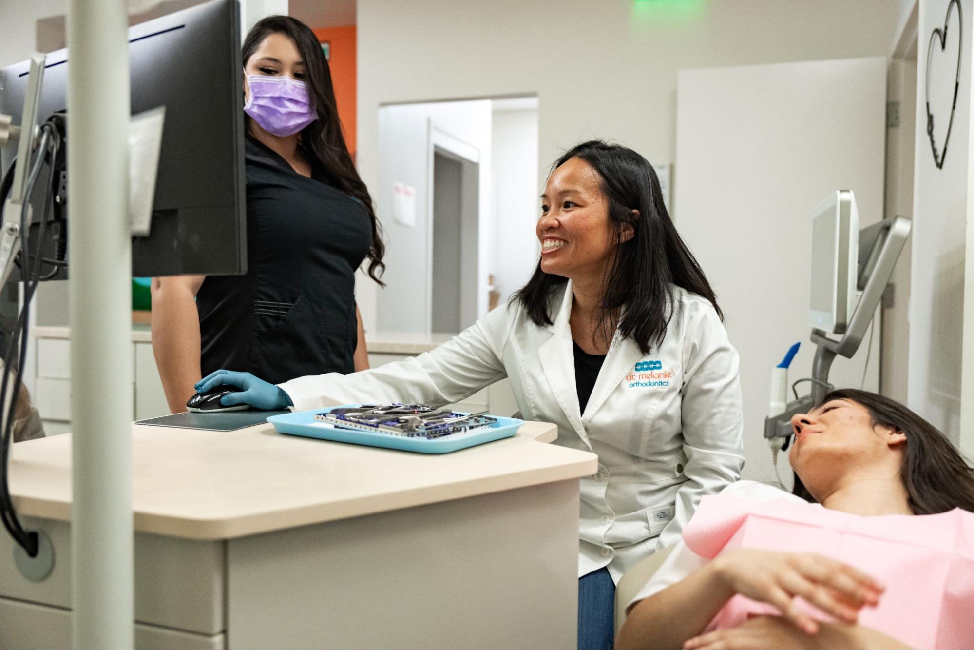 orthodontic team adjusting braces for patient in San Diego